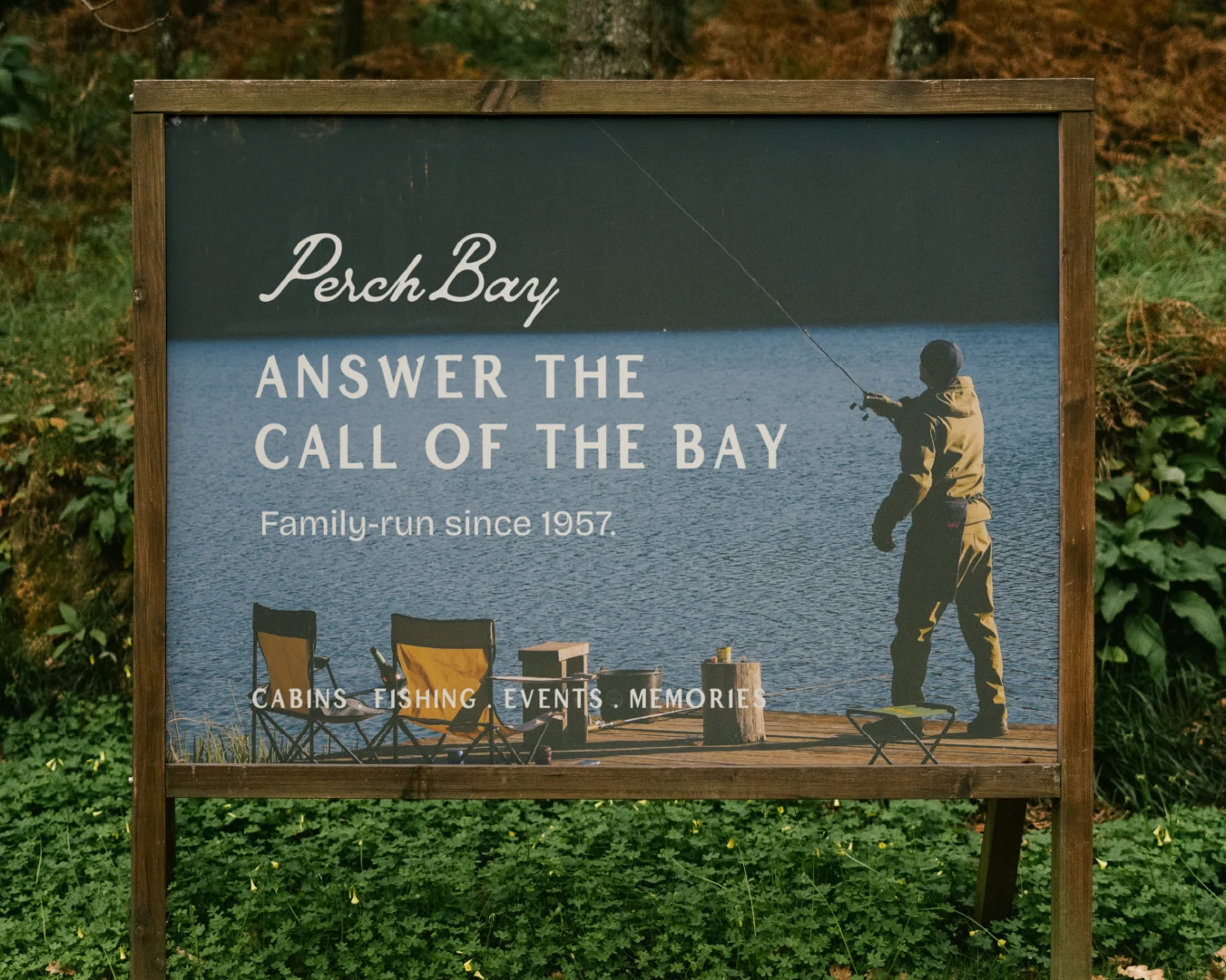 Outdoor Perch Bay Resort sign featuring a person fishing from a dock and the message “Answer the Call of the Bay.”