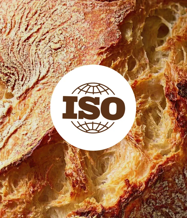 Close-up of crusty artisan bread with an ISO logo overlay in the center.