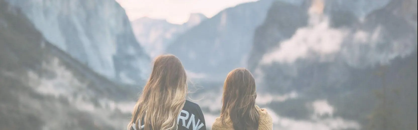 two girls in the mountains from behind