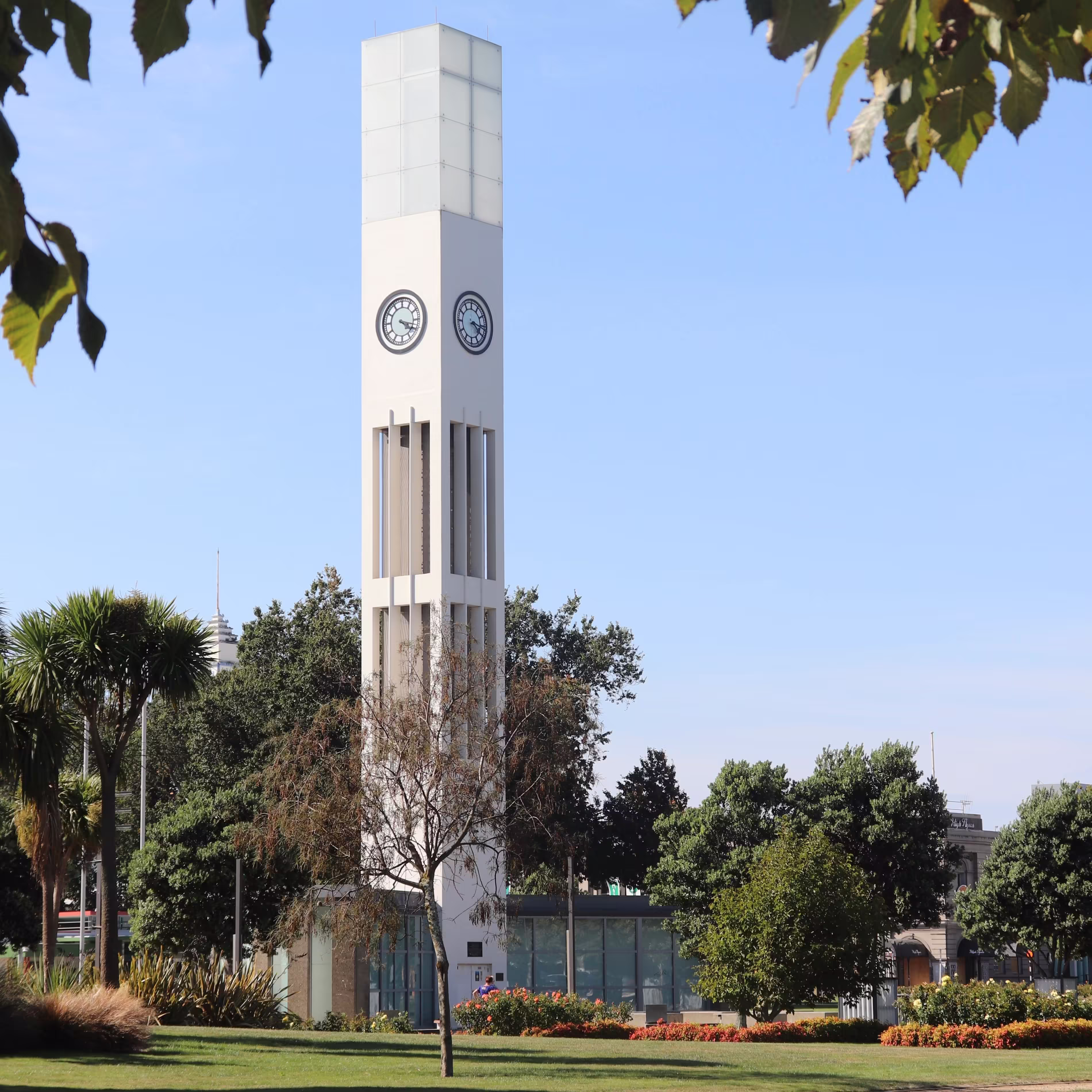 A garden with a clocktower in the middle of it