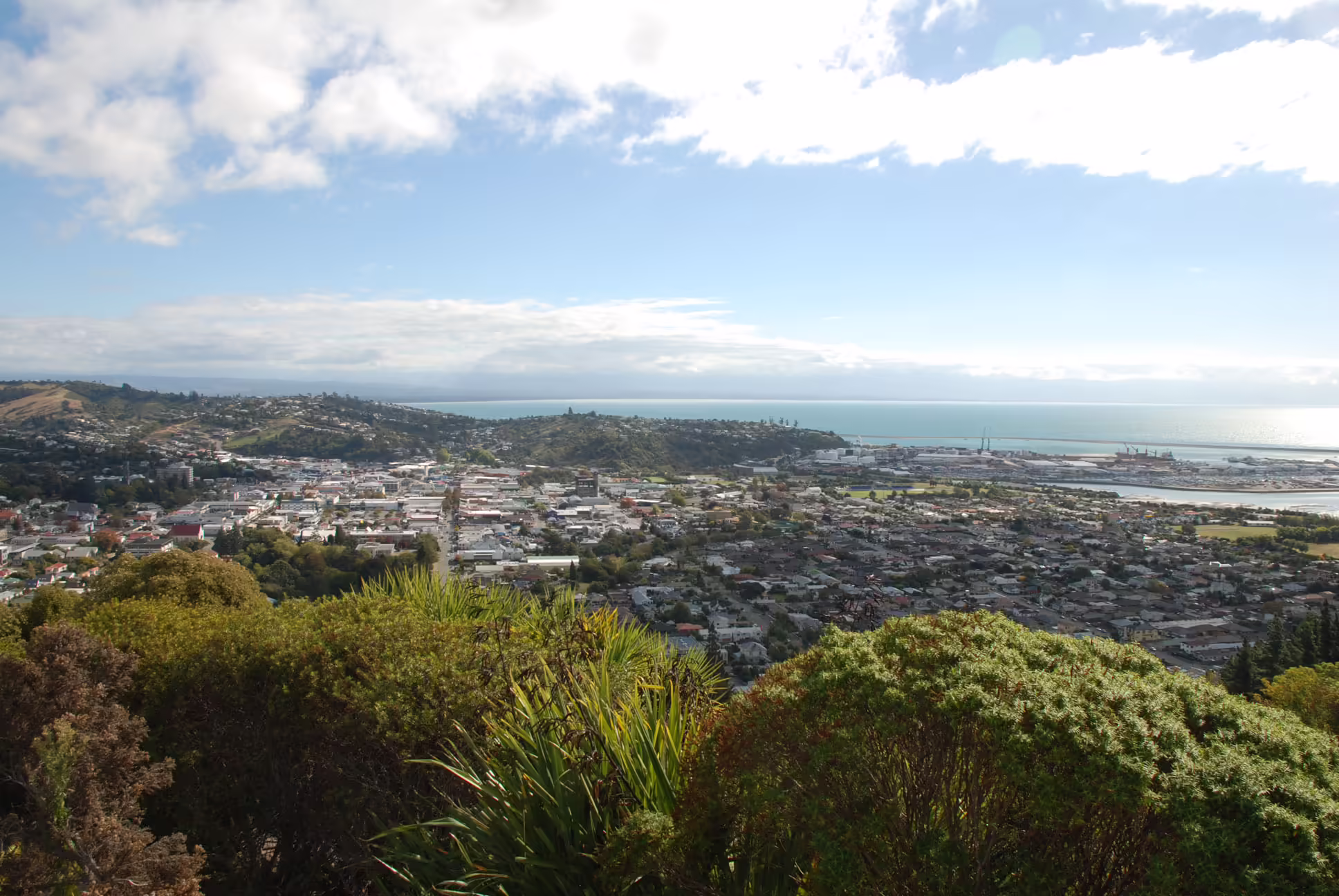 A photo from the top of a hill looking down on a town