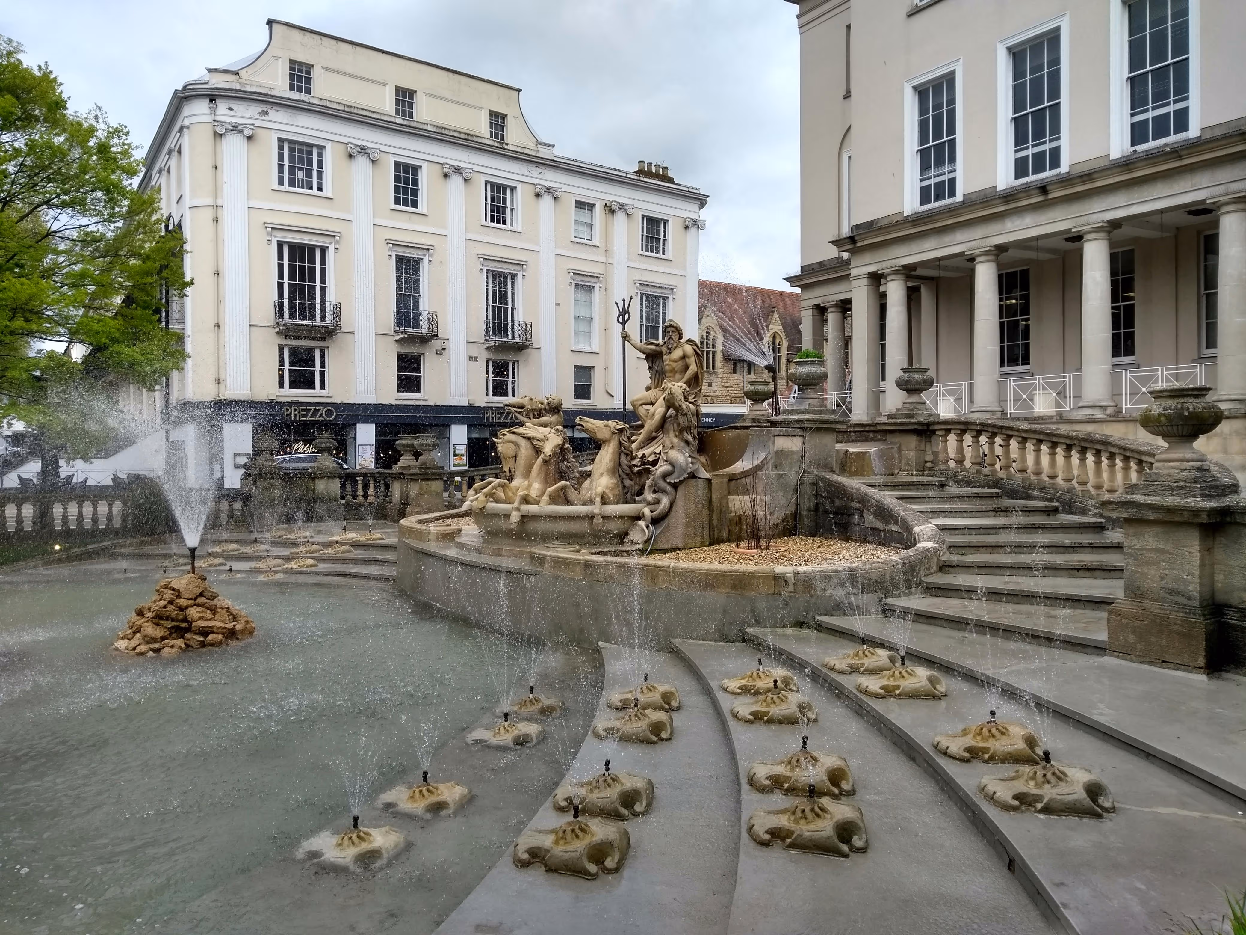 A large waterfountain on a town square