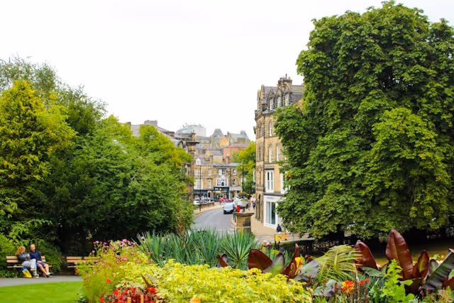 Flourishing gardens with old buildings in the background