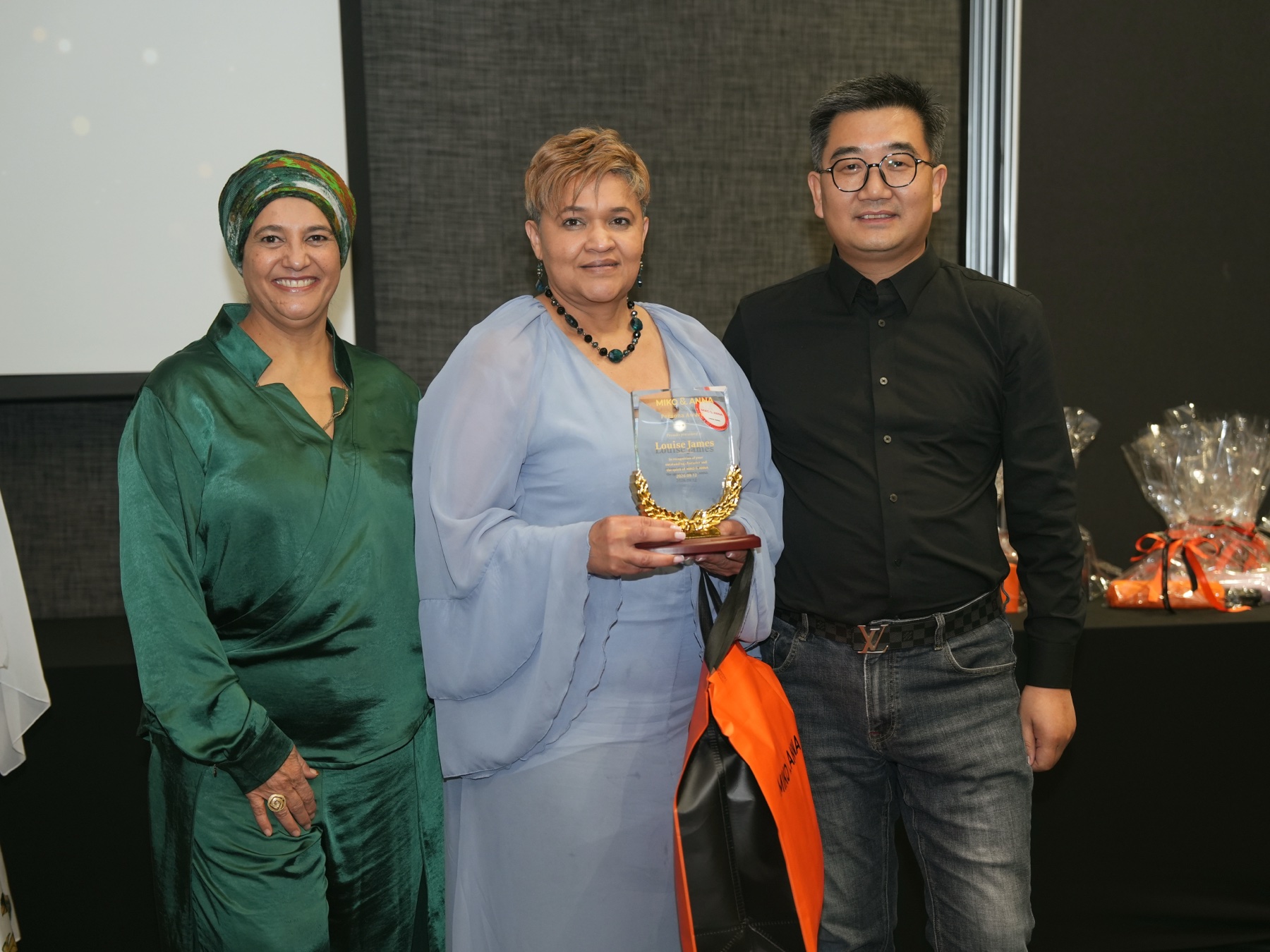 An award recipient with the Miko & Anna leadership team