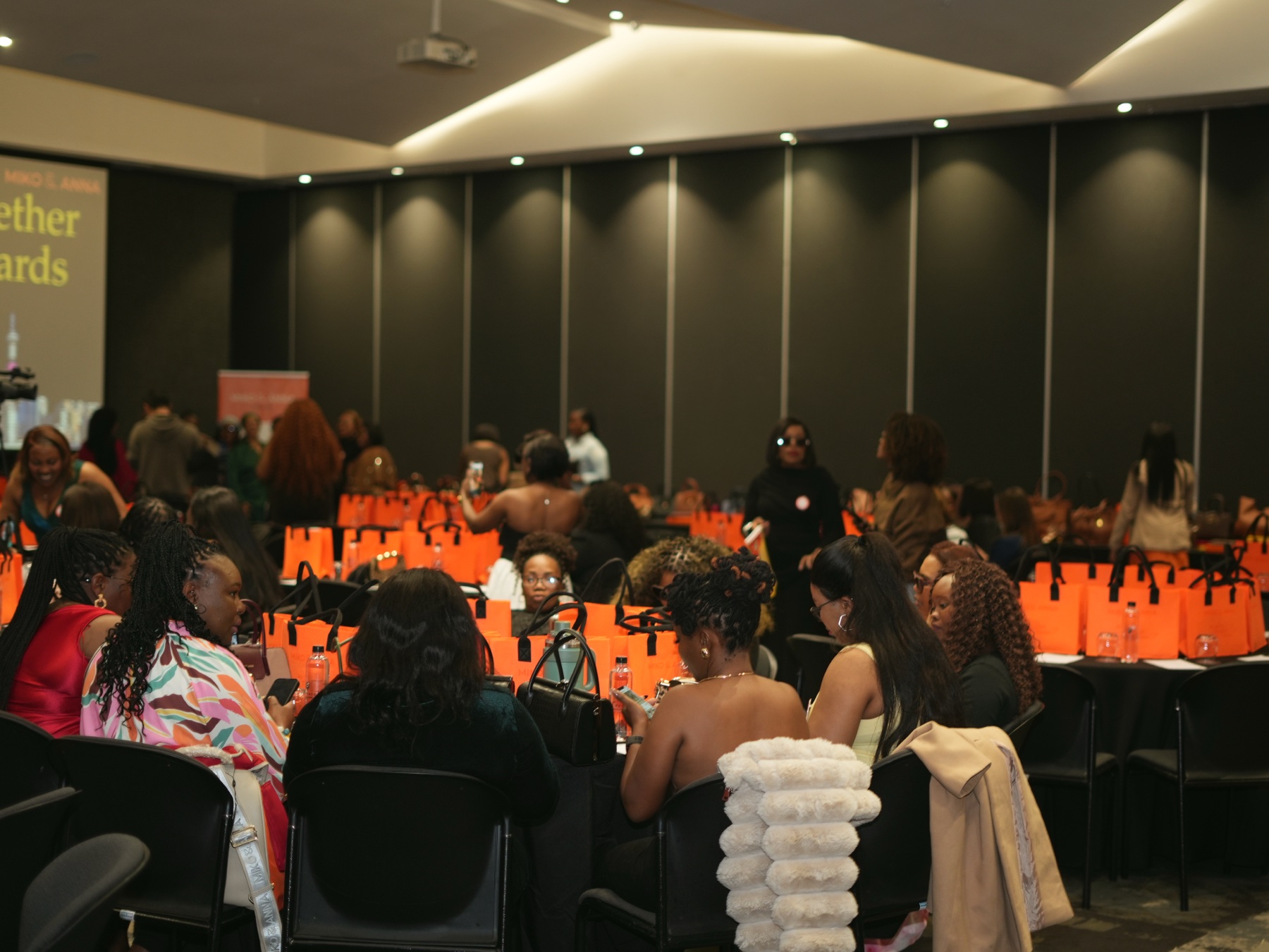 The conference room filled with ambassadors and orange Miko & Anna bags