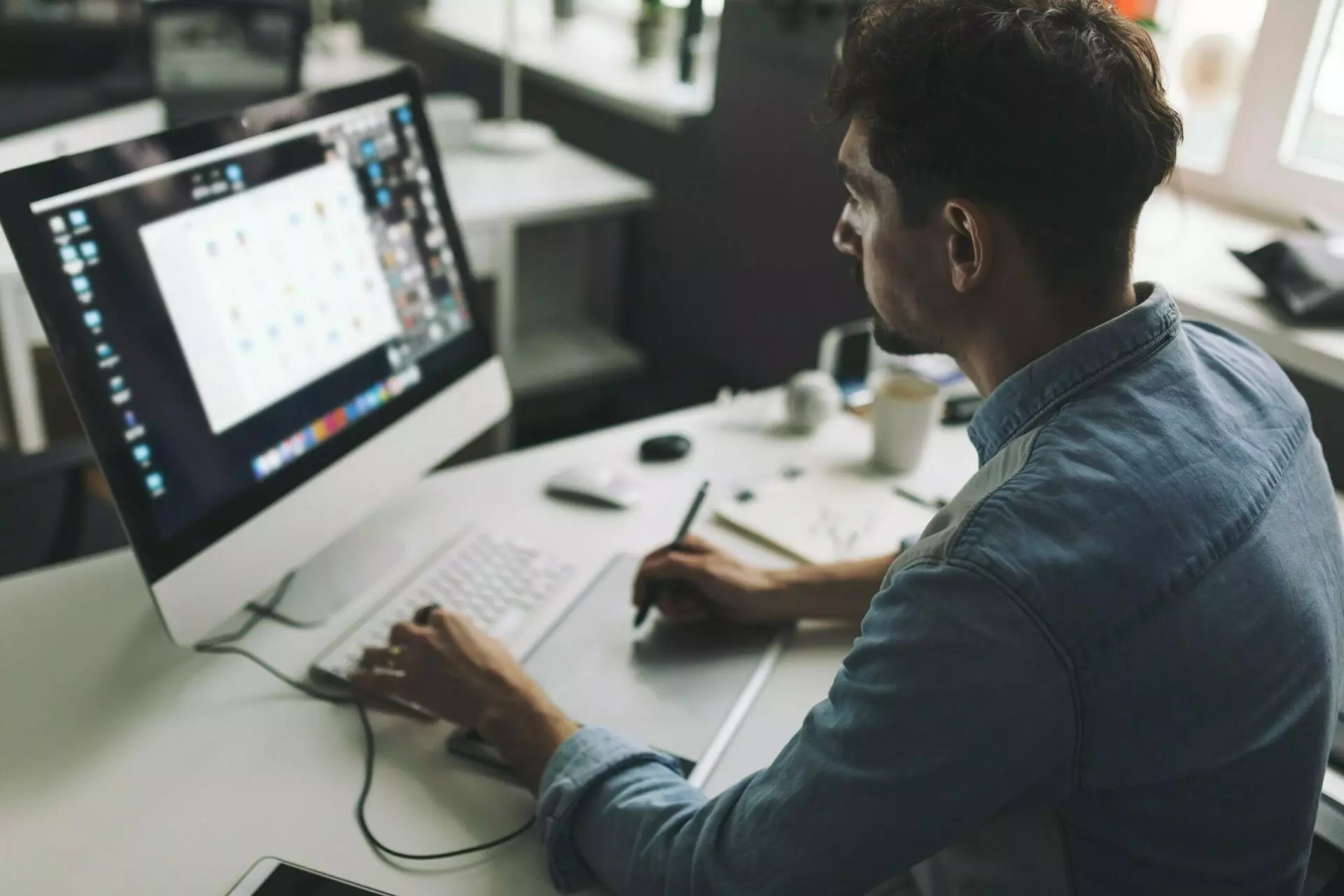 Male graphic designer in front monitor