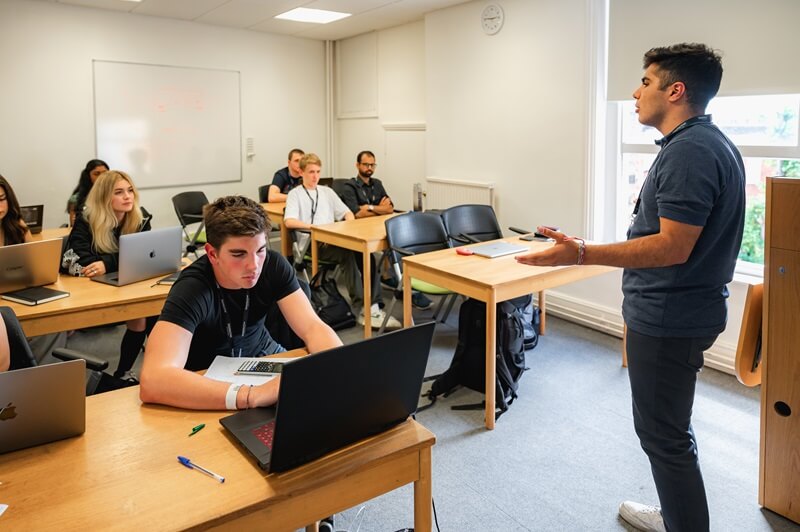 Tutor guiding students during a software development session