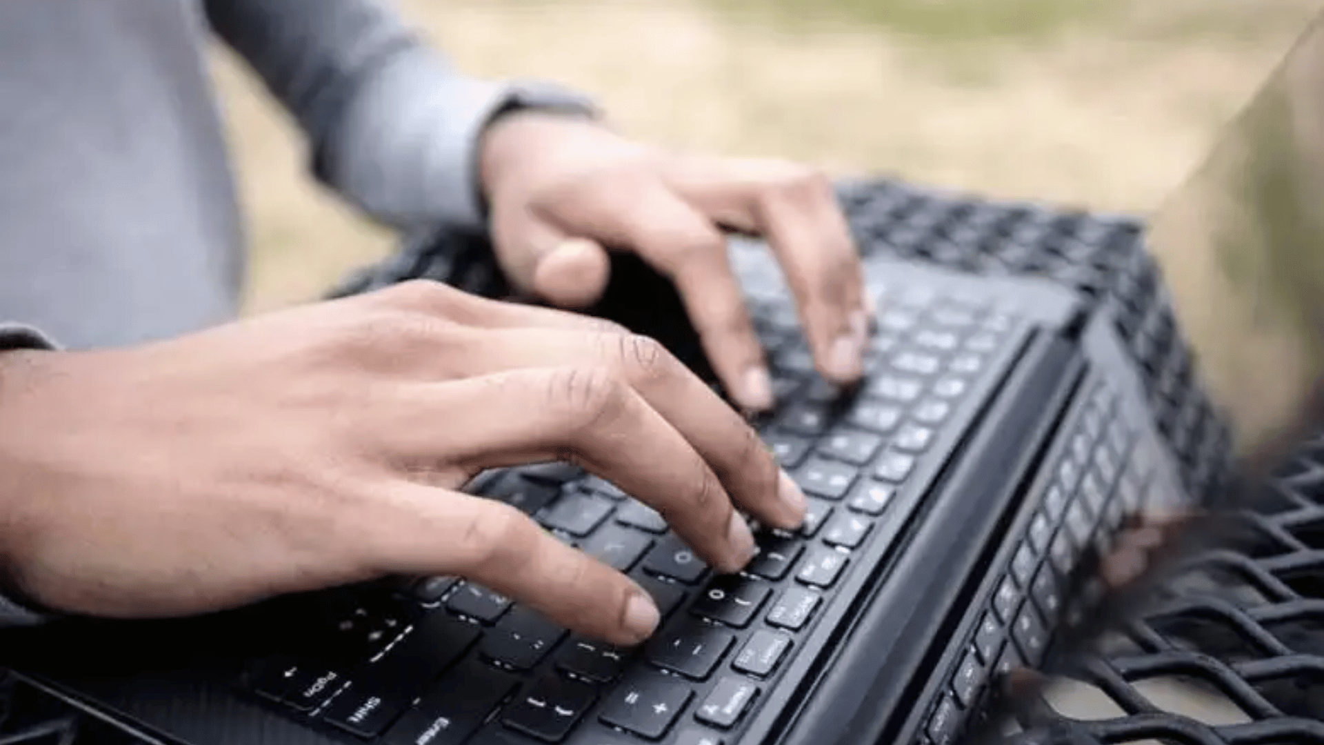 A student typing on a laptop