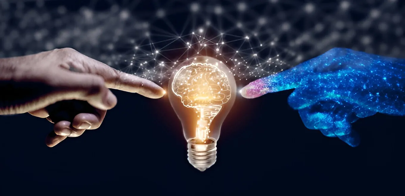 Human and digital hand connecting through AI lightbulb