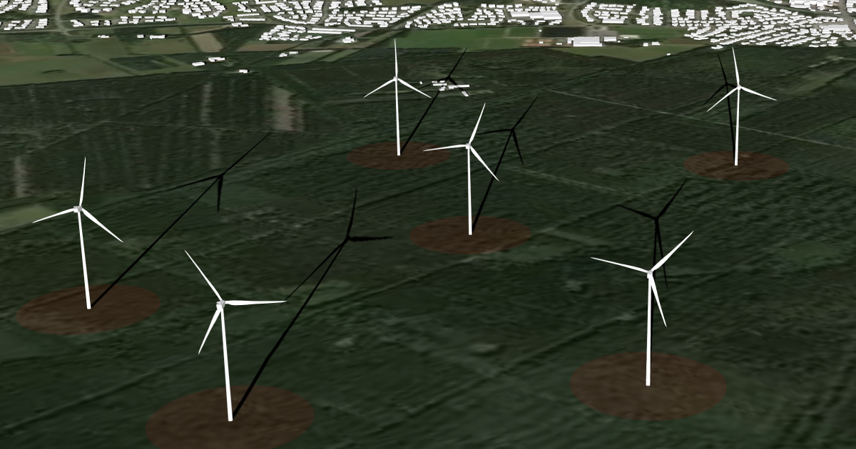 Several turbines in a field with visible turbine shadows