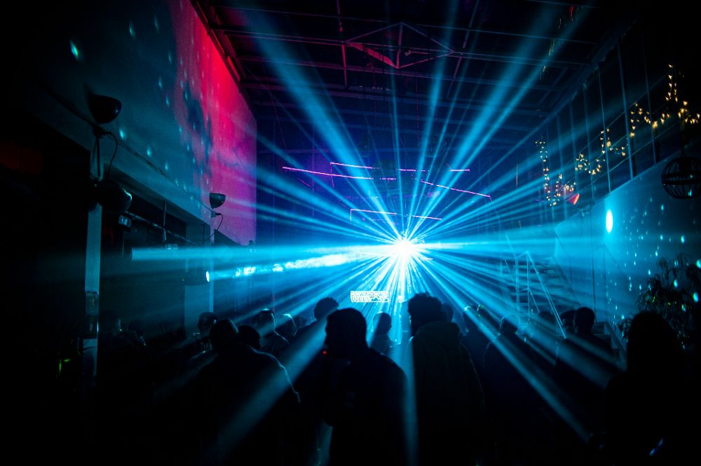 A picture of a dance club with dark and blue light