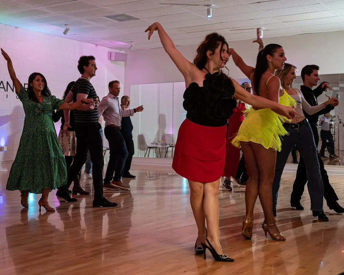 Couples practicing Ballroom and Latin routines during a social dance class at a studio offering the best dance for couples to learn in Playa Del Rey.