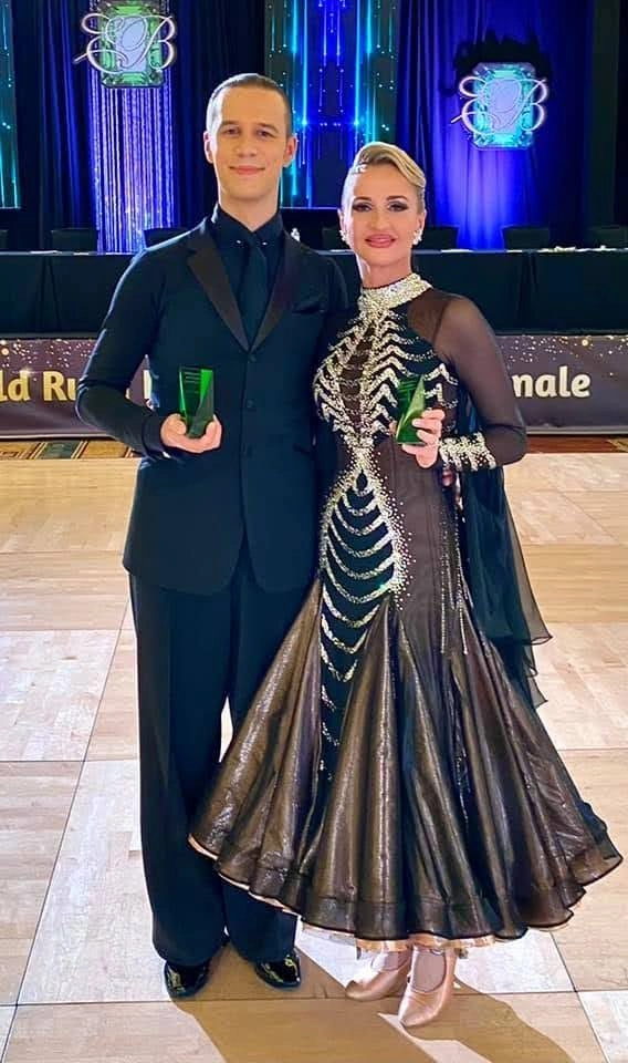 A dancing couple posing for a picture after they won a dance competition. Their dancing skill was refined by taking Dance Lessons in Playa Del Rey. 