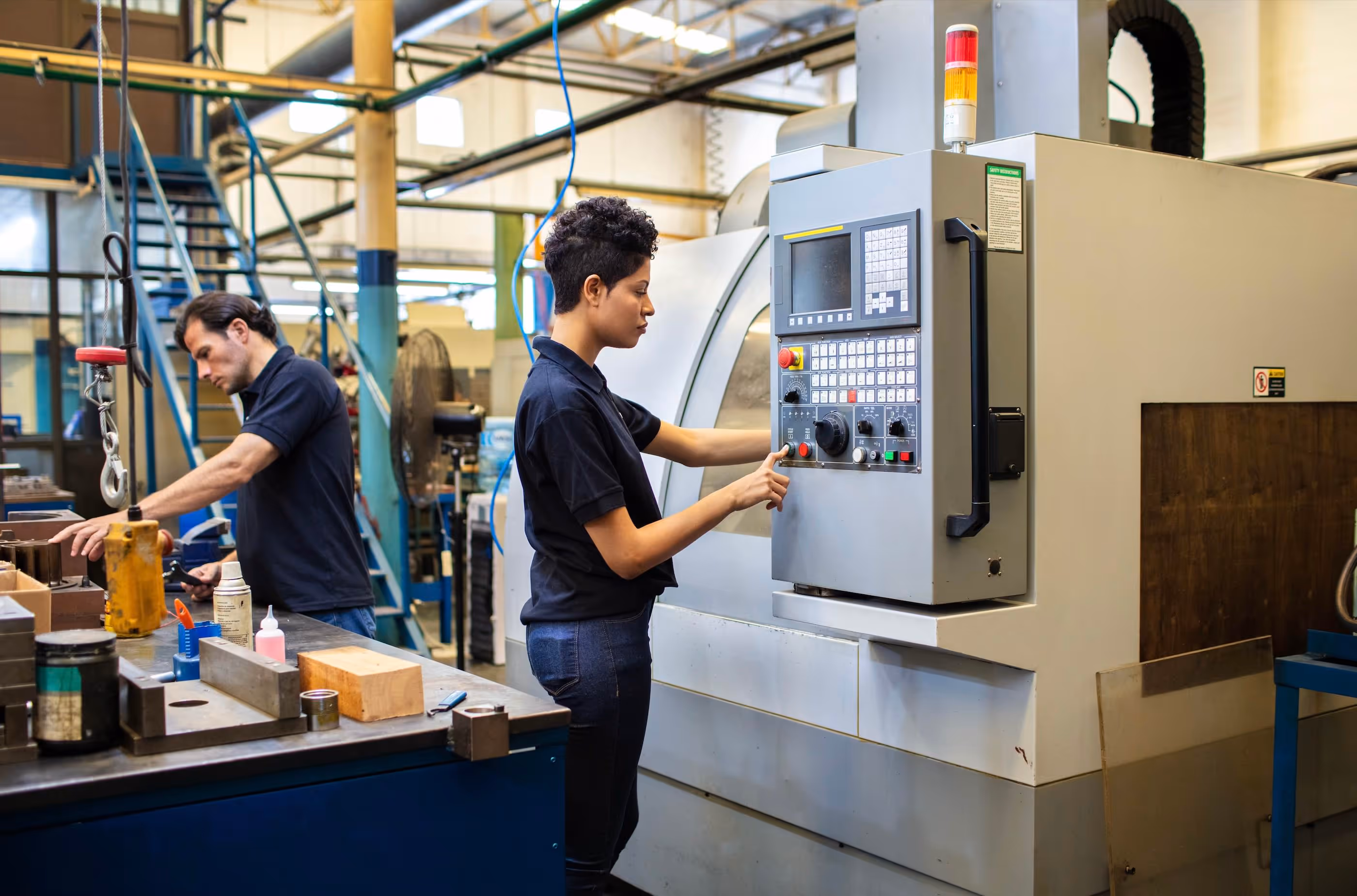 A woman programming a CNC machine.