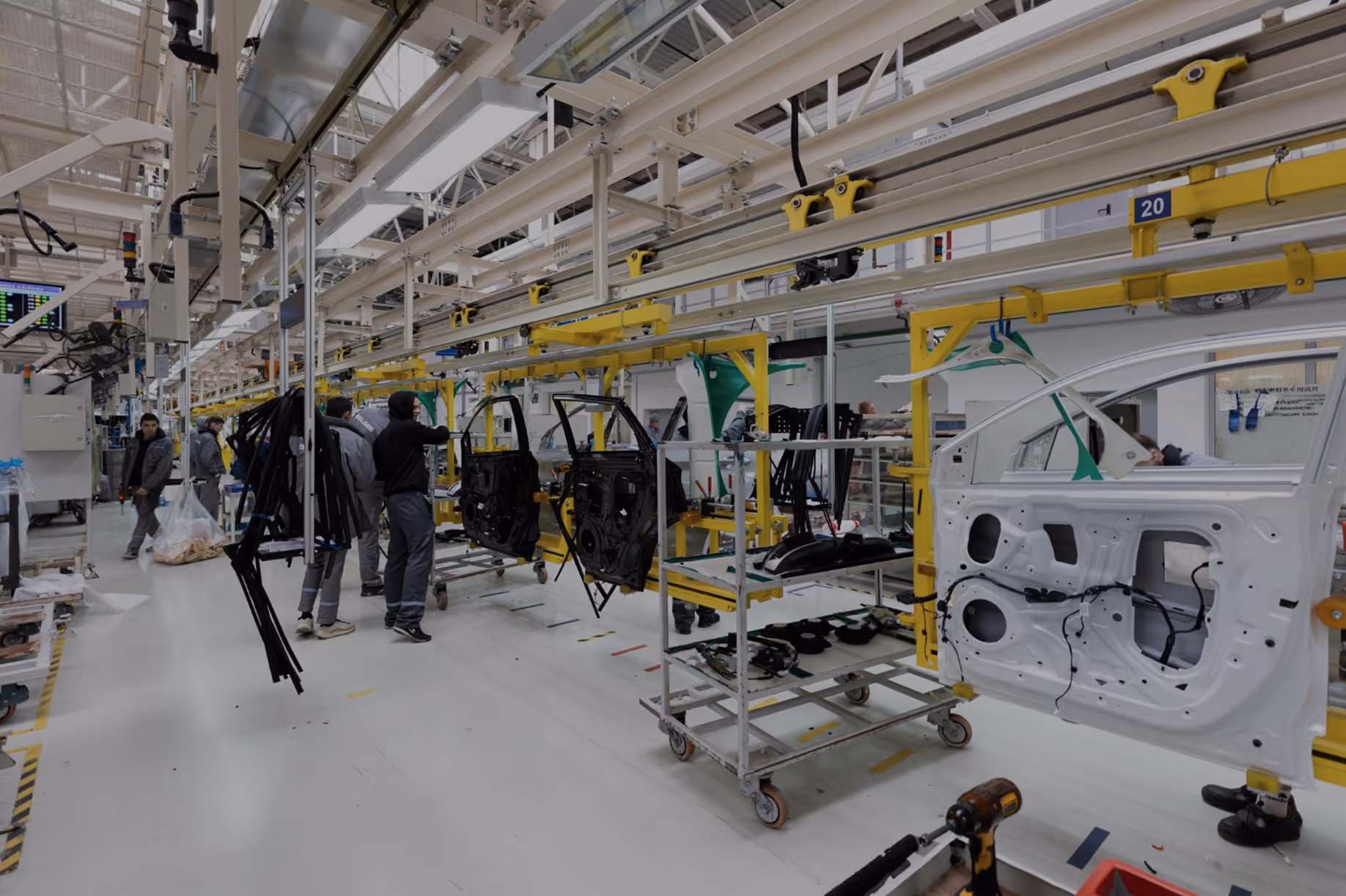 A shop floor with car parts being moved around.
