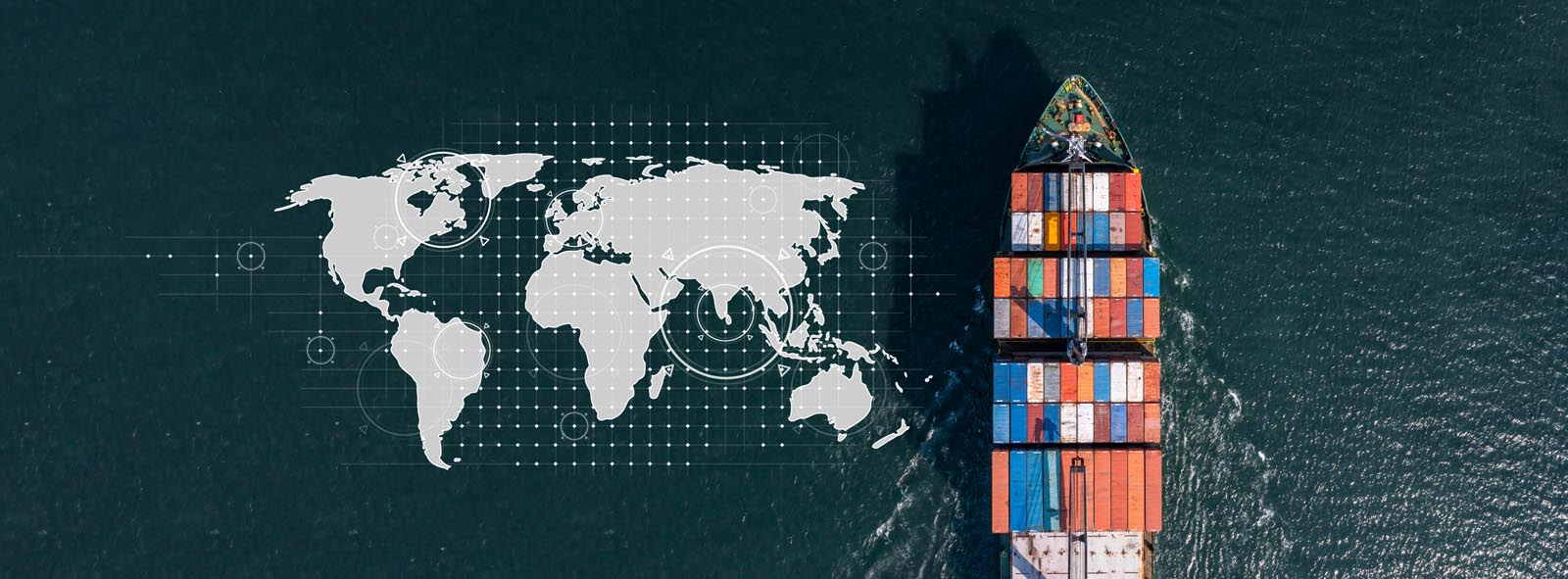 Aerial view of a cargo ship carrying multicolored containers sailing on dark ocean water next to a digital world map graphic.