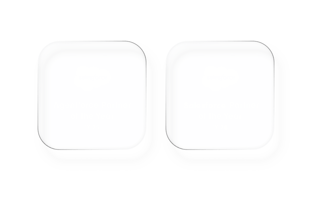 Two men in white shirts clapping and smiling while seated at a table during an event.