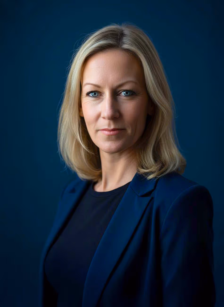 Maven Radd lawyer, Jenna Bartlett - with blonde hair, wearing a navy blazer, set against a dark blue background. She has an engaged expression.