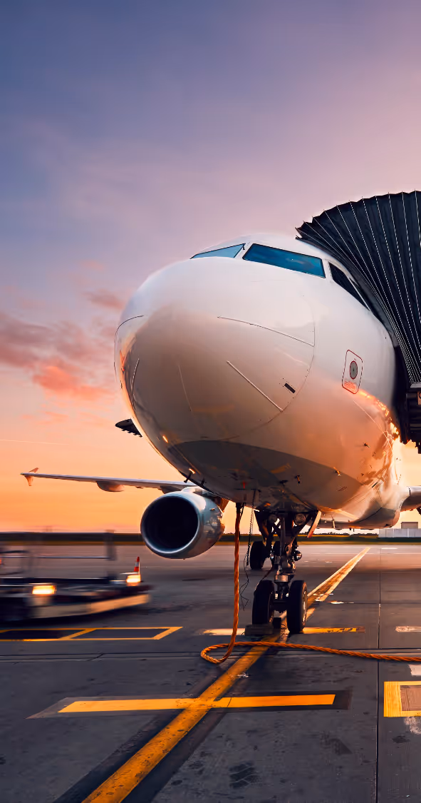 Metafuels technology - Airplane at sunset on the runway, showcasing the nose and one engine with service vehicle nearby.