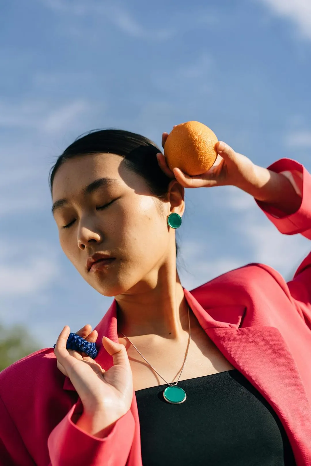 Image of a woman holding an orange.