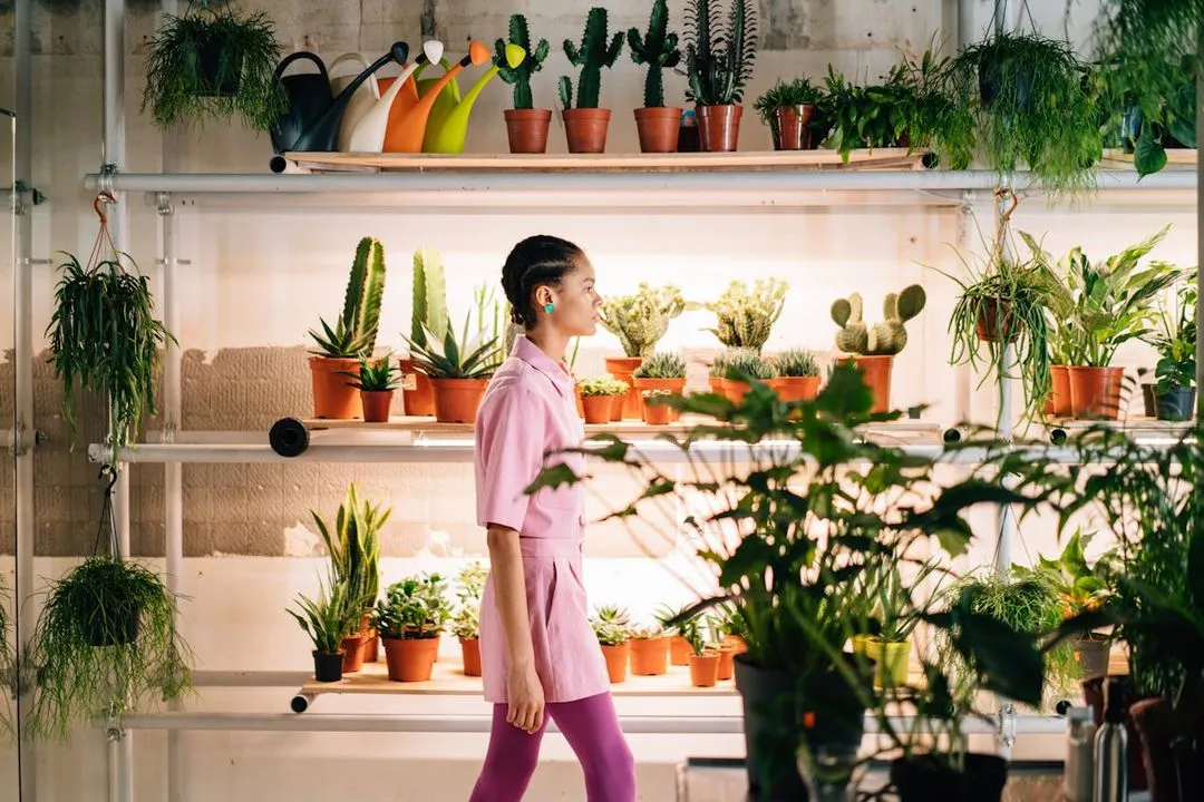 Woman walking across a plant shop.