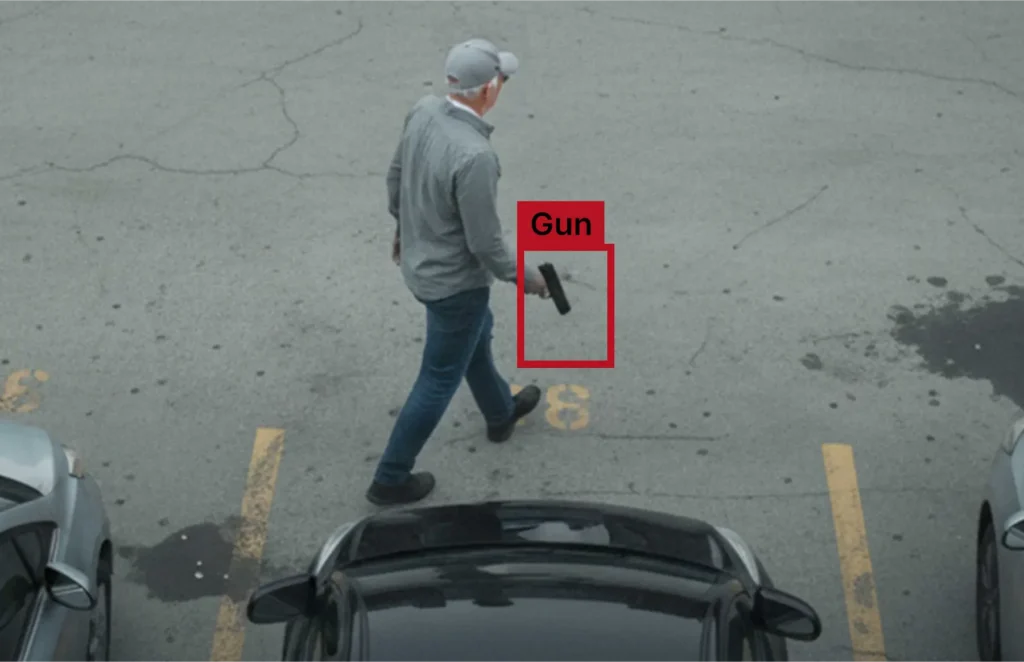 Security camera footage with AI highlighting a potential weapon detection event.