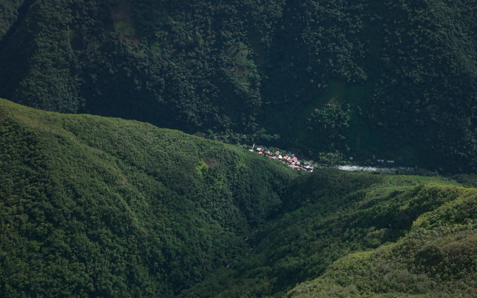 View of a village deep in a forested valley