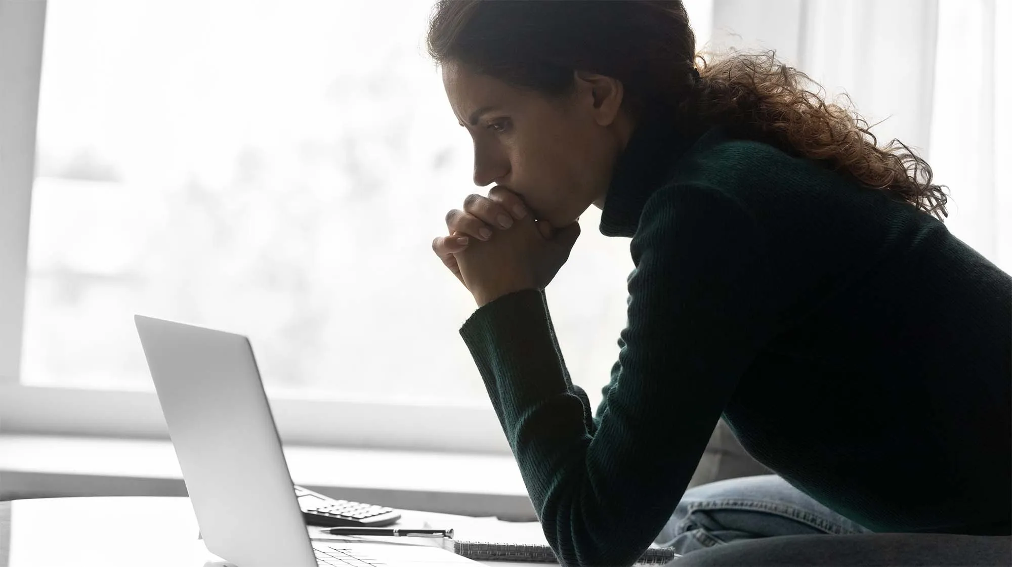 Woman with hands on her chin, thinking. 