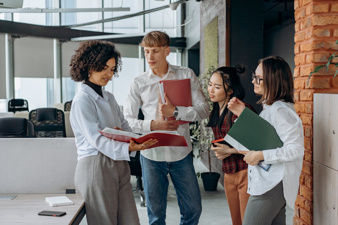 Free Business Colleagues Reading Documents in the Office Stock Photo
