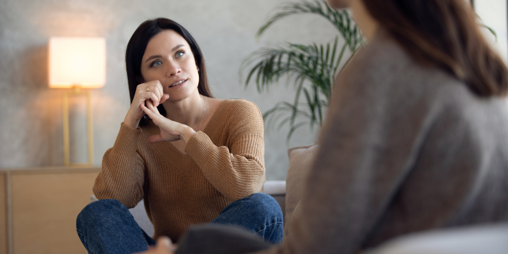 Two women sitting having a conversation about impostor syndrome