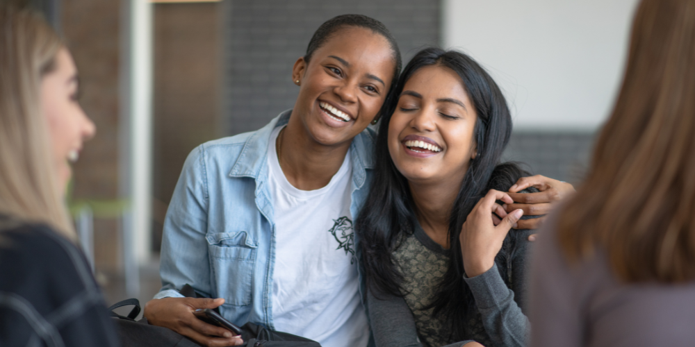 Two women hugging and supporting each other