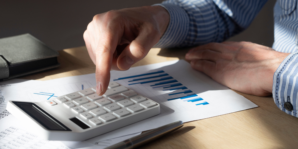 a close up view of a hand doing calculations on a calculator