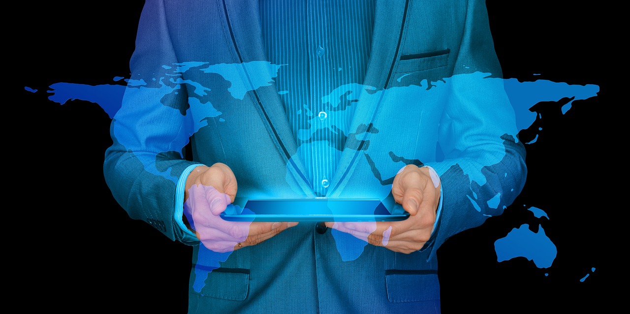 A man with a tablet projecting a map of the world
