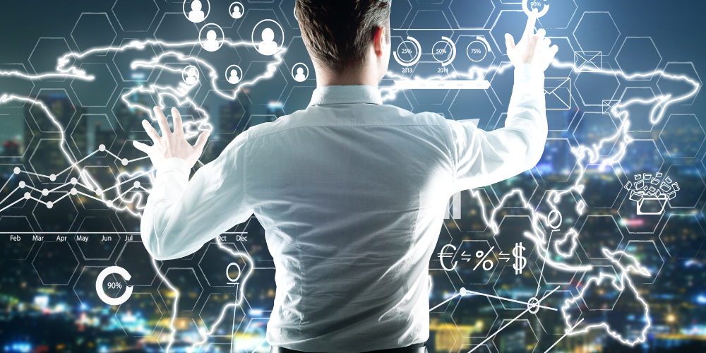 A person is interacting with a futuristic holographic display showing various graphs, user icons, percentages, and financial symbols, suggesting an advanced interface for data analysis or social network visualization. The setting appears to be an office or a technologically advanced workspace.