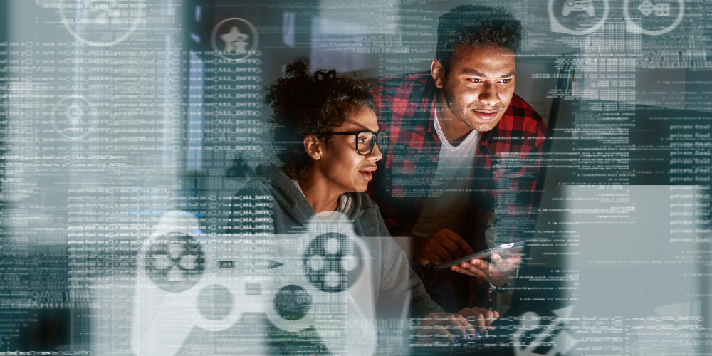 Two professionals are focused on a screen with digital data and graphics overlaying the image, indicating a tech or data-driven environment.