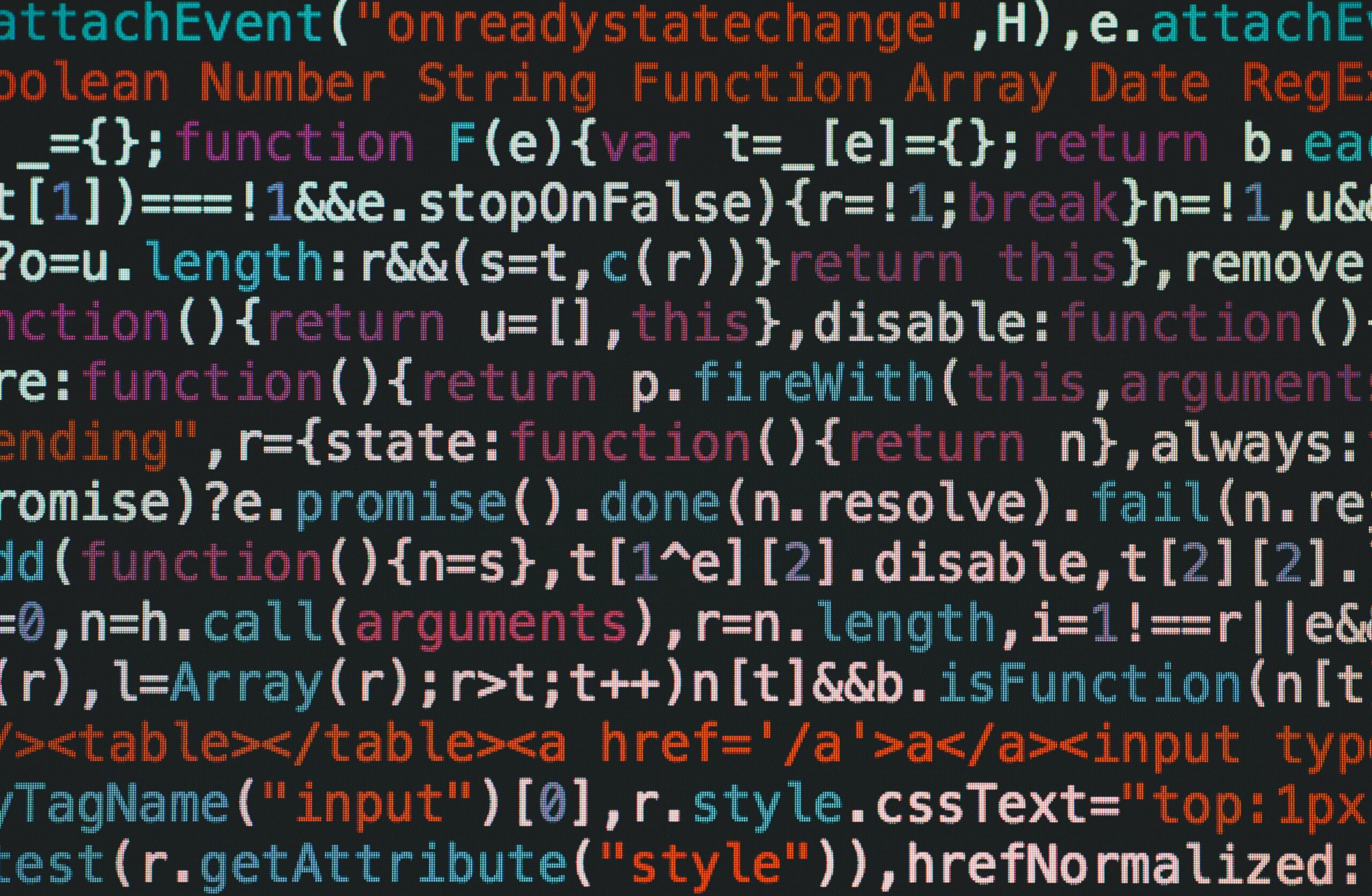 Close-up of a computer screen displaying colorful programming code, with sharp focus on specific syntax elements.