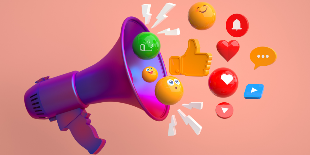 The image features a vibrant 3D illustration of a purple megaphone with various social media emojis and icons bursting out of it, set against a peach-colored background. Visible icons include a thumbs-up, a heart, emoji faces, a speech bubble, and symbols for video play and notifications. This representation likely signifies the concept of social media engagement, viral content, or digital marketing communication. The icons are glossy and have a playful, eye-catching appearance.
