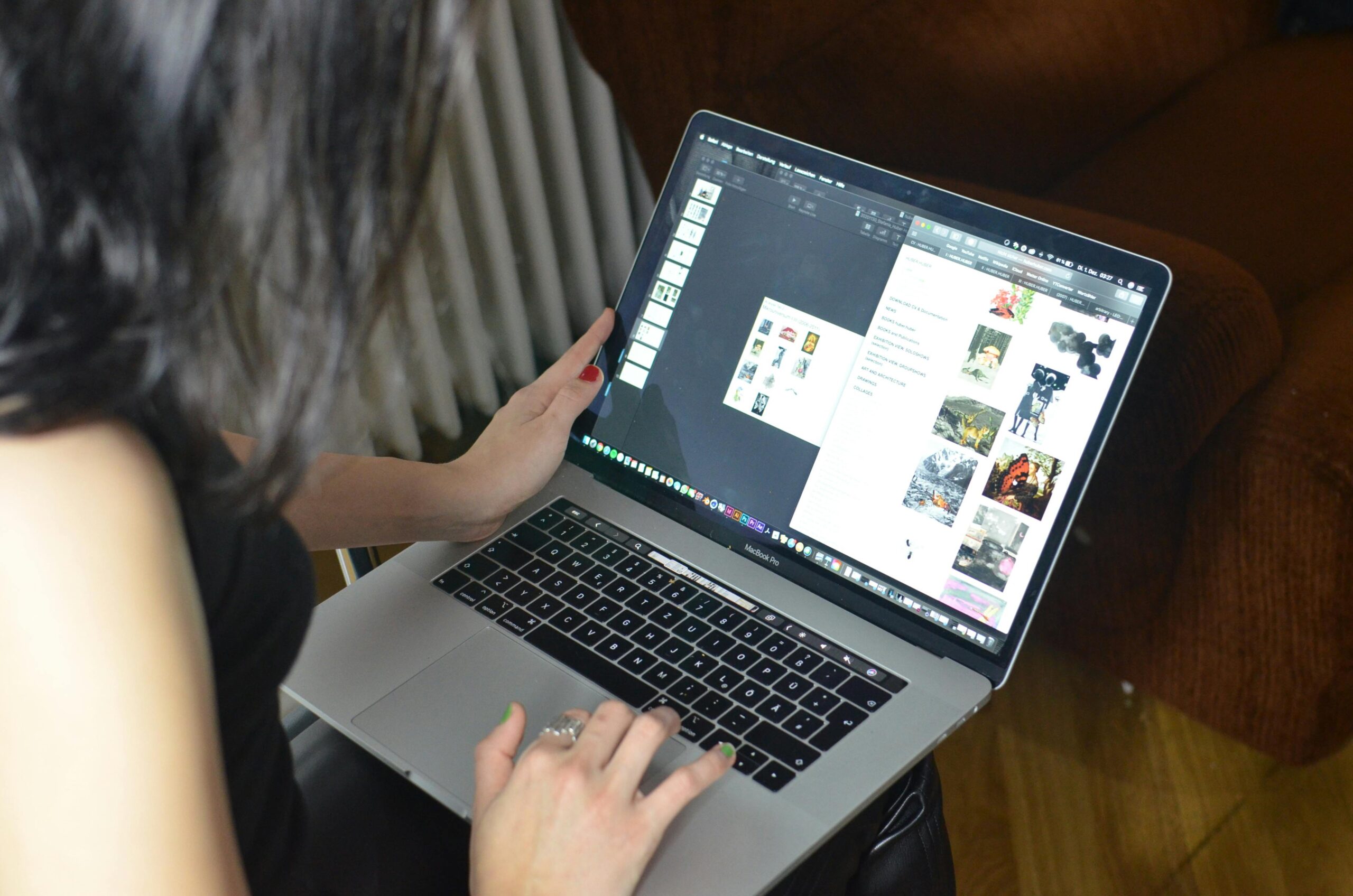 Over-the-shoulder view of a person working on a laptop with a photo editing application open.