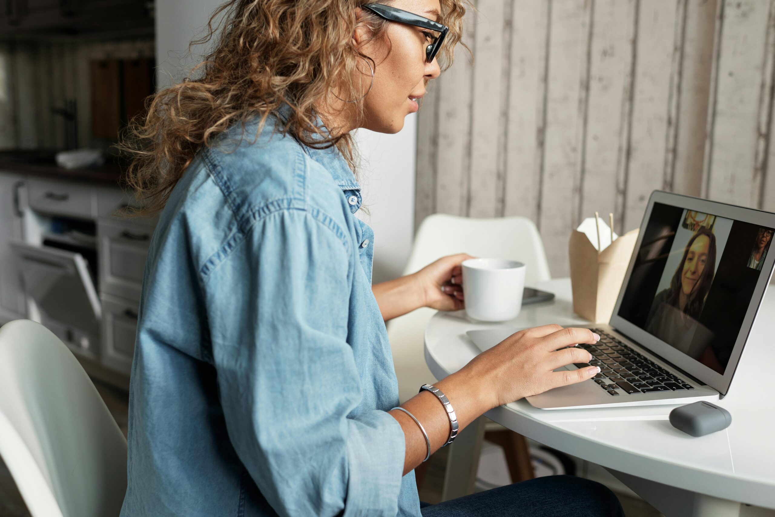 A person attending an online meeting from a home office