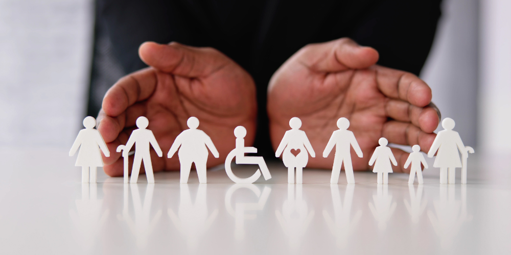 Cut-out figures representing a diverse range of people and family structures, emphasizing inclusivity.