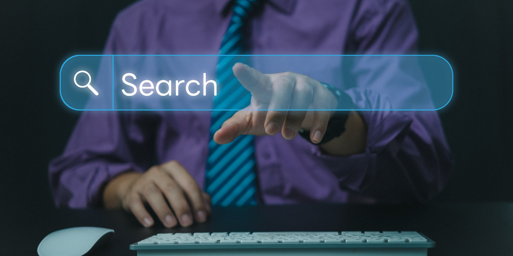 A man in a shirt and tie reaching towards a digital search bar projected in front of him, implying a modern or futuristic online search.