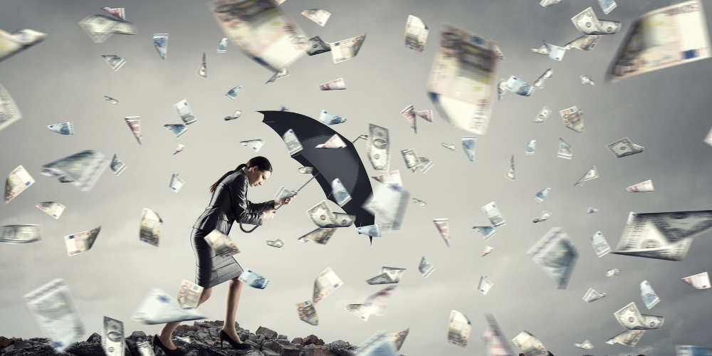 A surreal image of a woman holding an umbrella as banknotes fly around in a stormy sky, symbolizing financial turbulence or economic chaos.