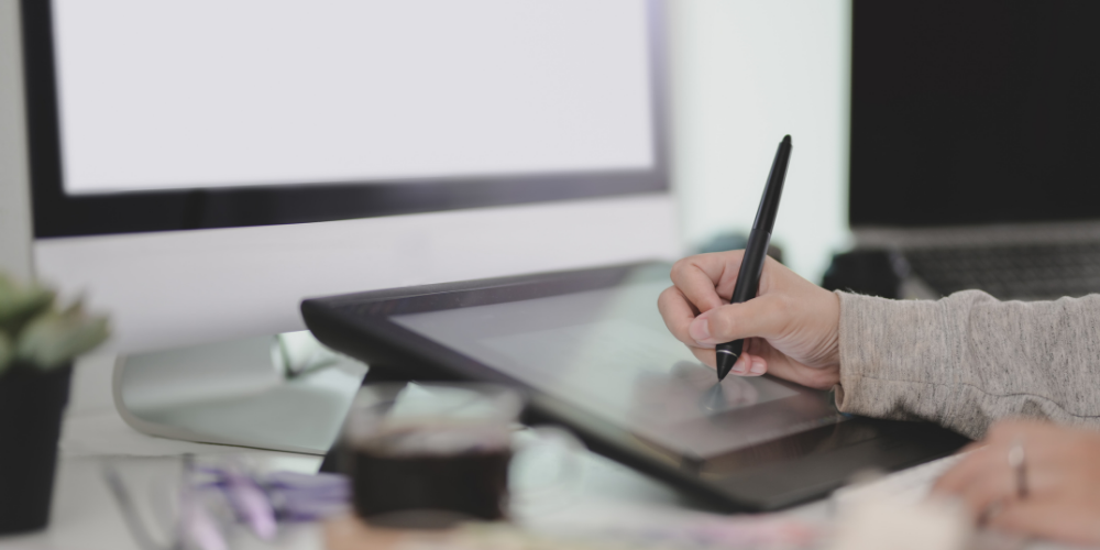 A graphic designer using a stylus on a drawing tablet, representing the type of skilled professionals staffing firms connect with businesses.