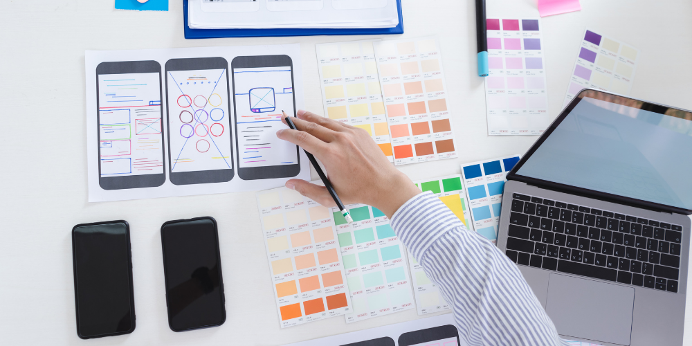 A professional planning a mobile app interface, showcasing the detail-oriented talent staffing firms provide to tech businesses.