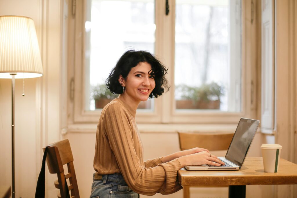 A freelancer in a café, representing flexible job opportunities through an outsourced employment agency.