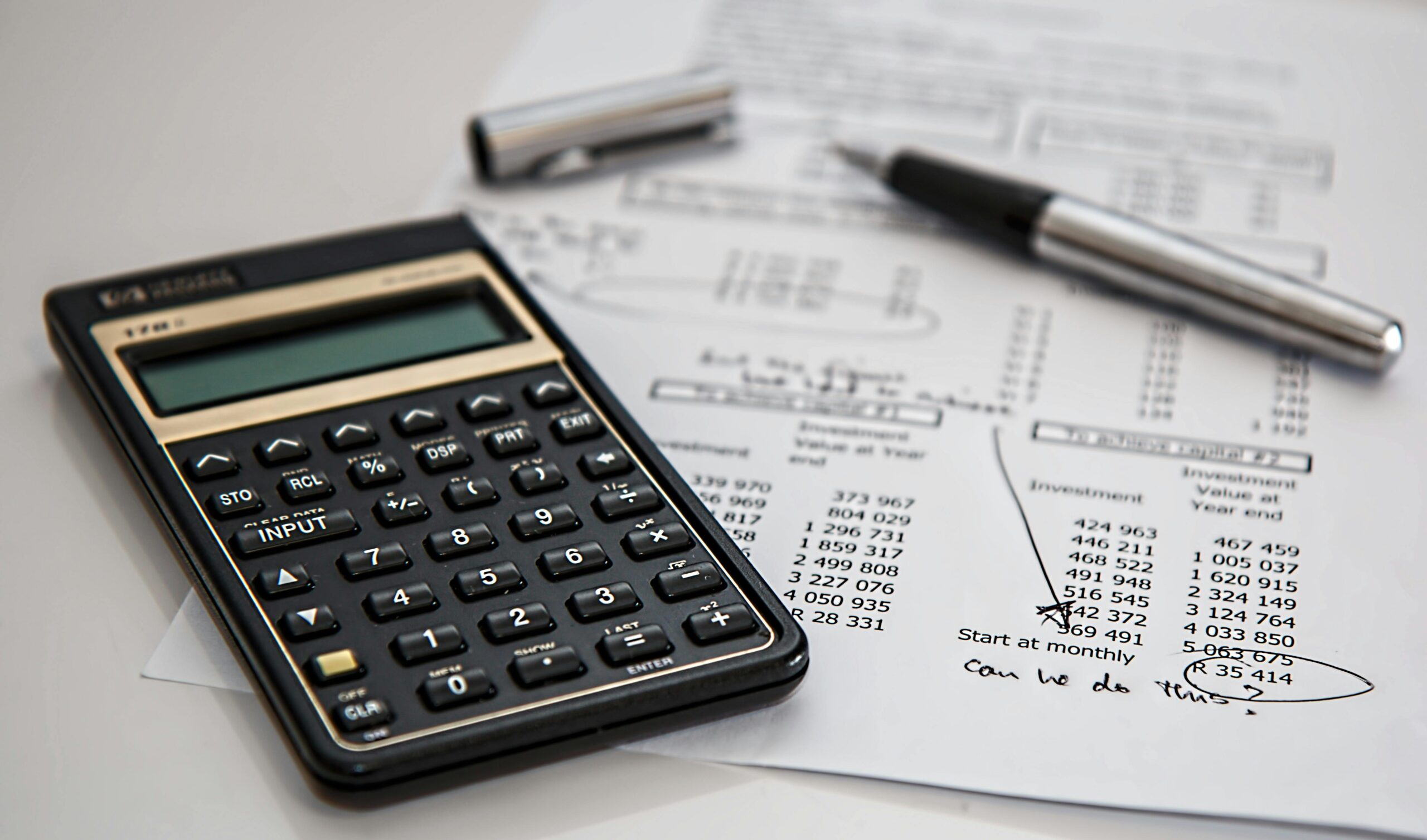 Calculator and financial documents for outsourcing accounts receivable.