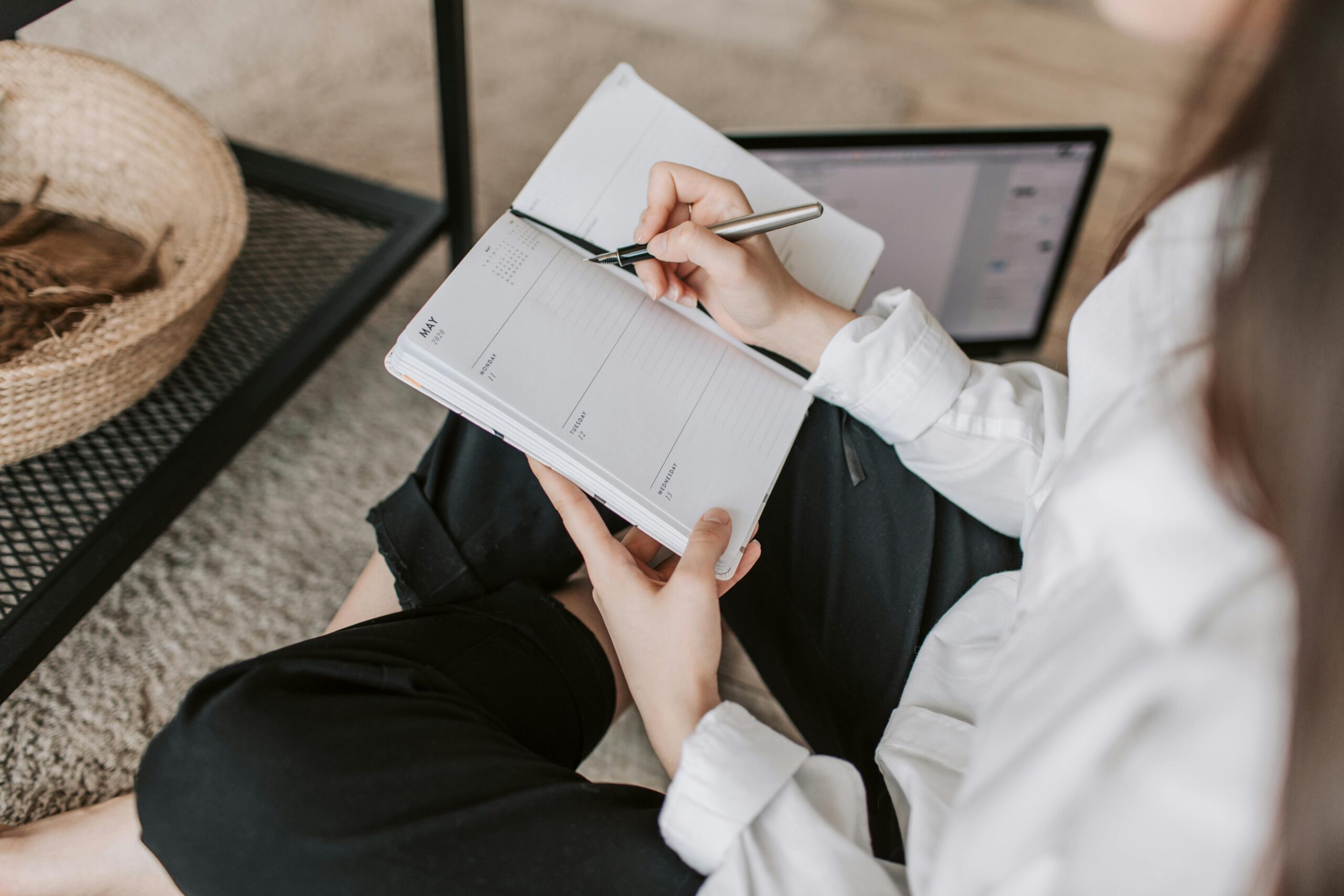 Woman organizing her schedule on a planner.