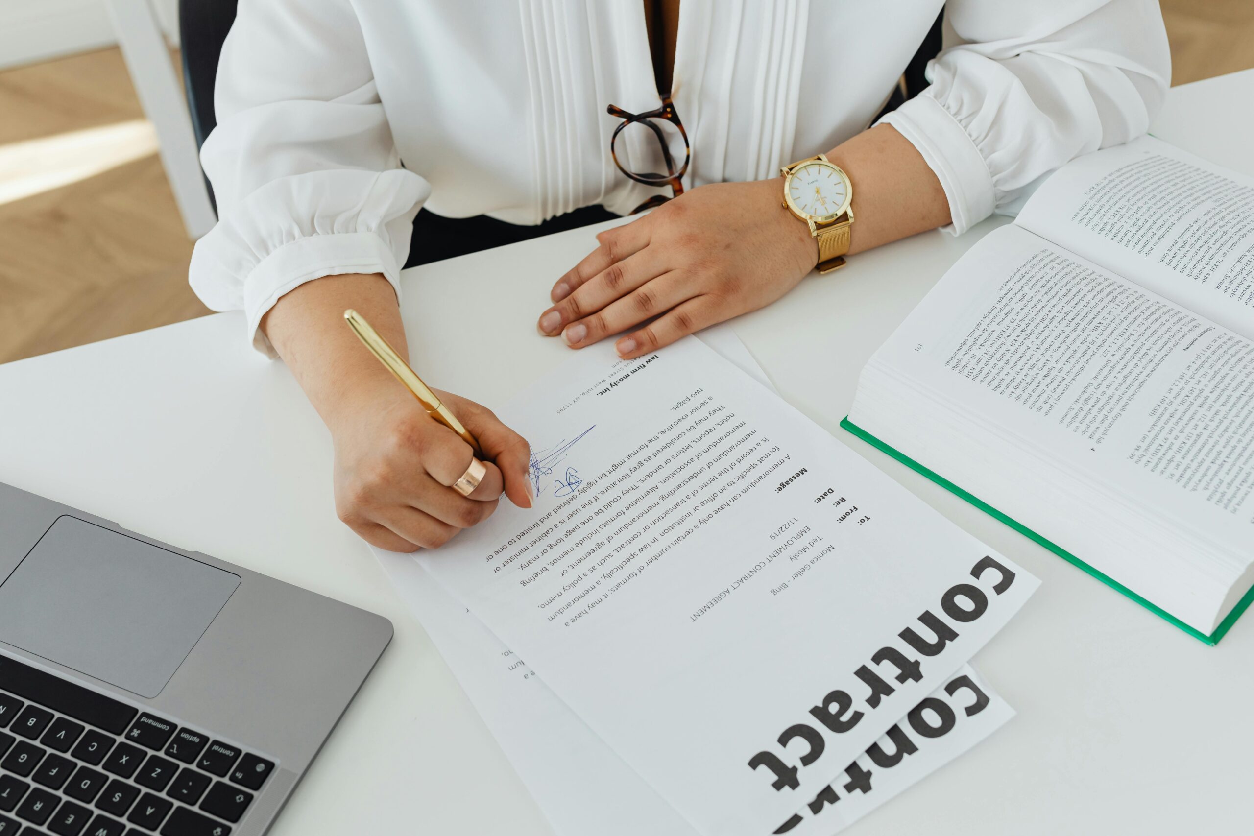Professional woman signing documents.