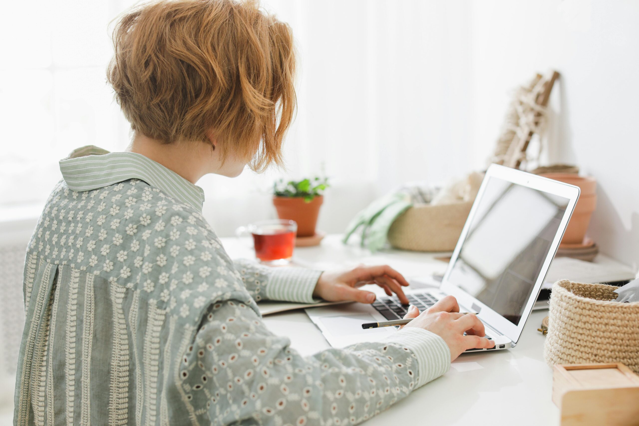 Woman working remotely on a laptop, exemplifying virtual administrative support in action.