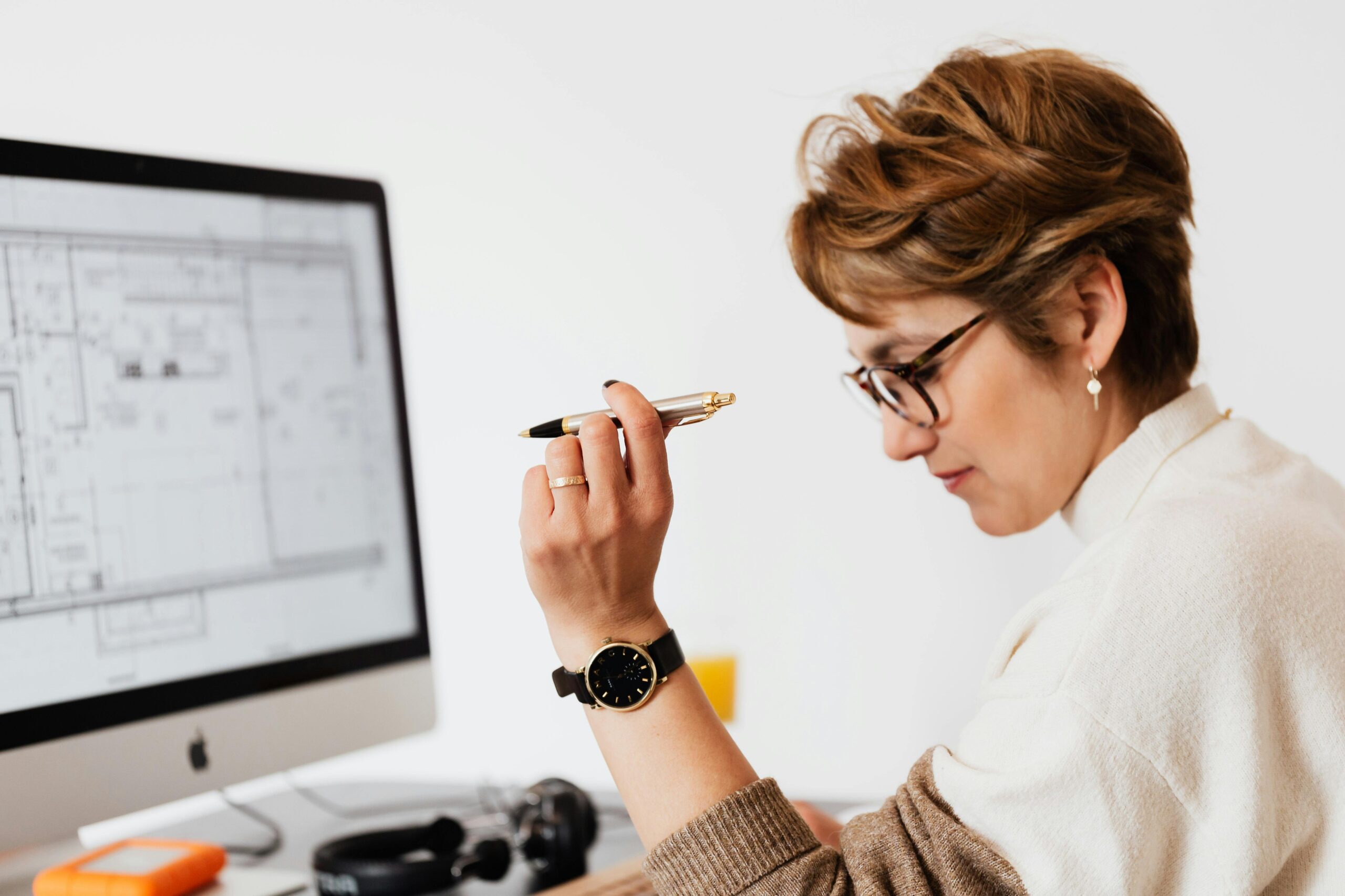 An individual reviews an architectural plan, embodying the talent hunter precision in scouting skilled professionals.